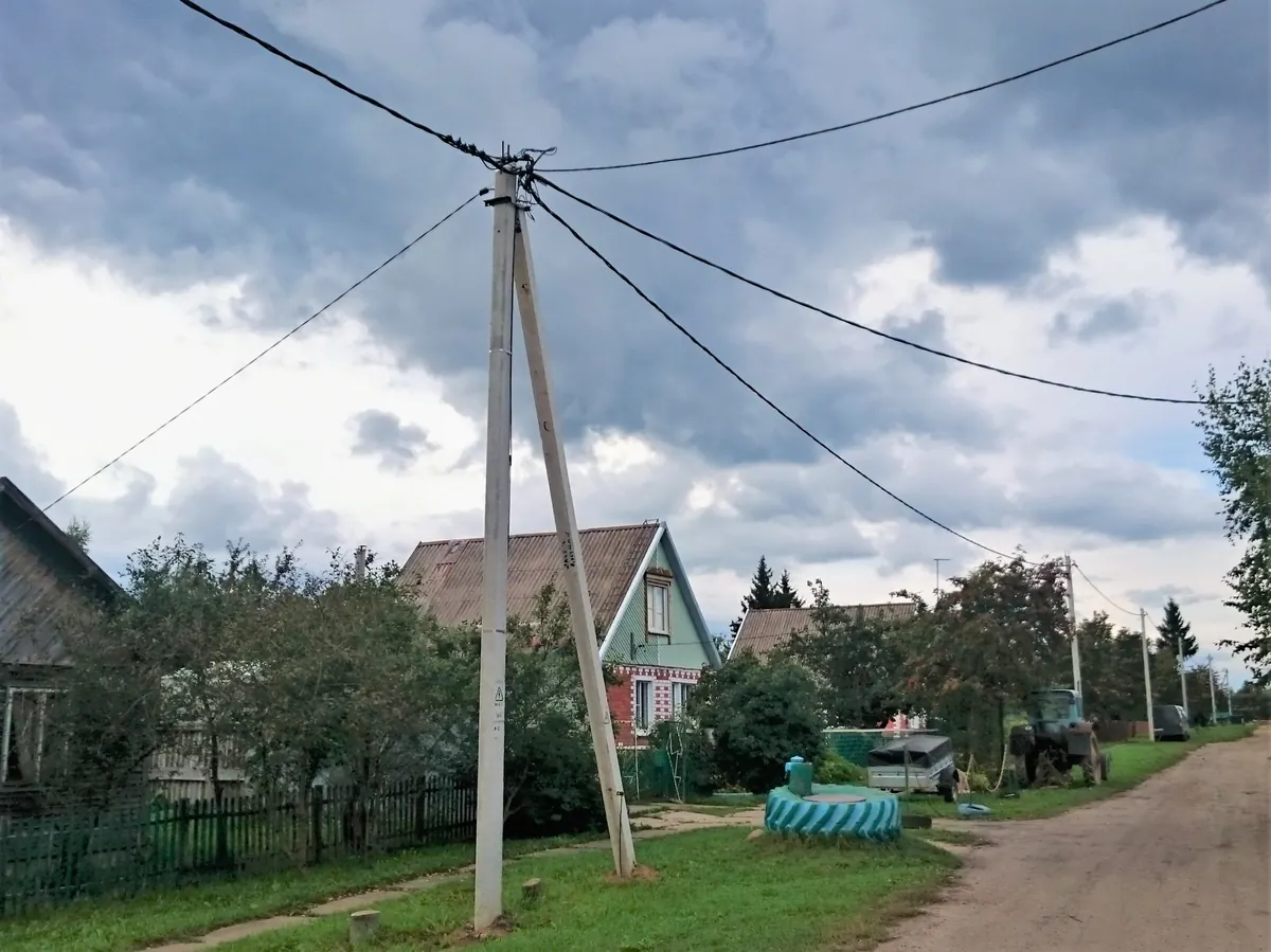 Aerial bundled cable crossing a rural low voltage overhead line