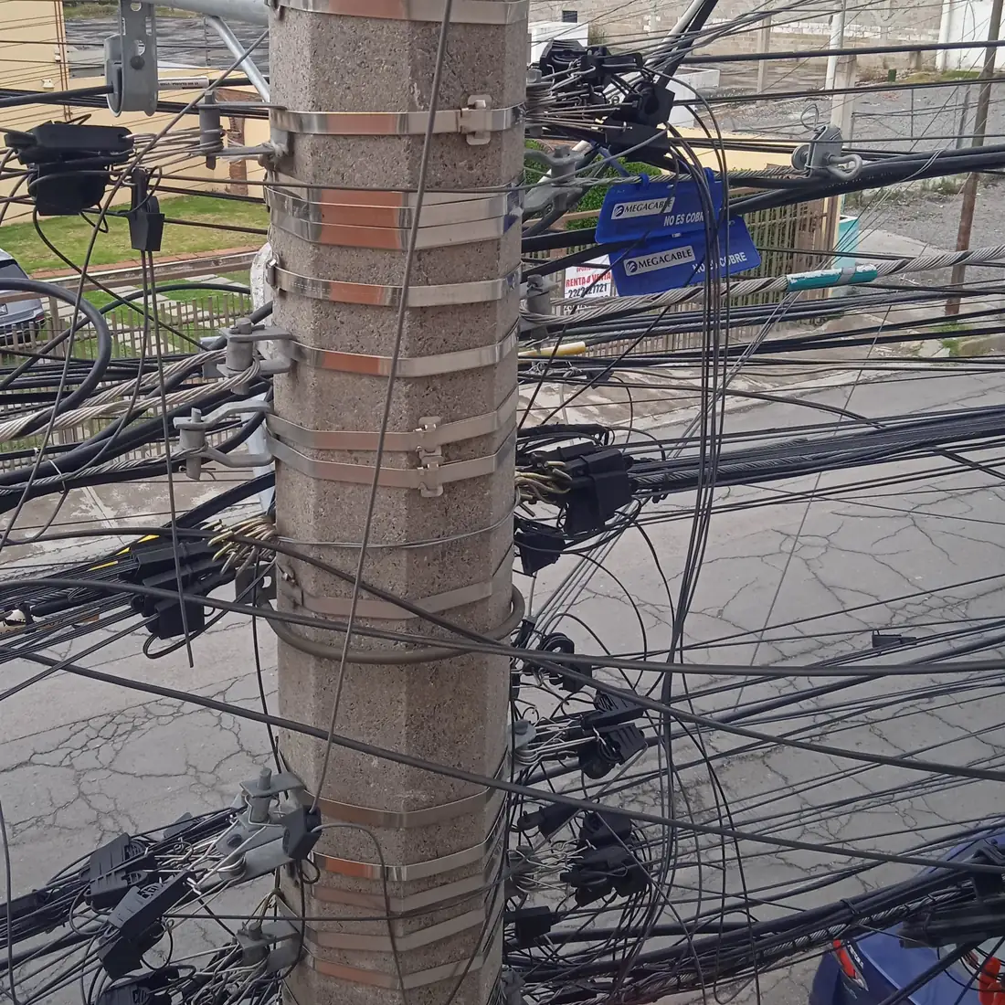 Attachment bands and clamps installed on a shared utility pole