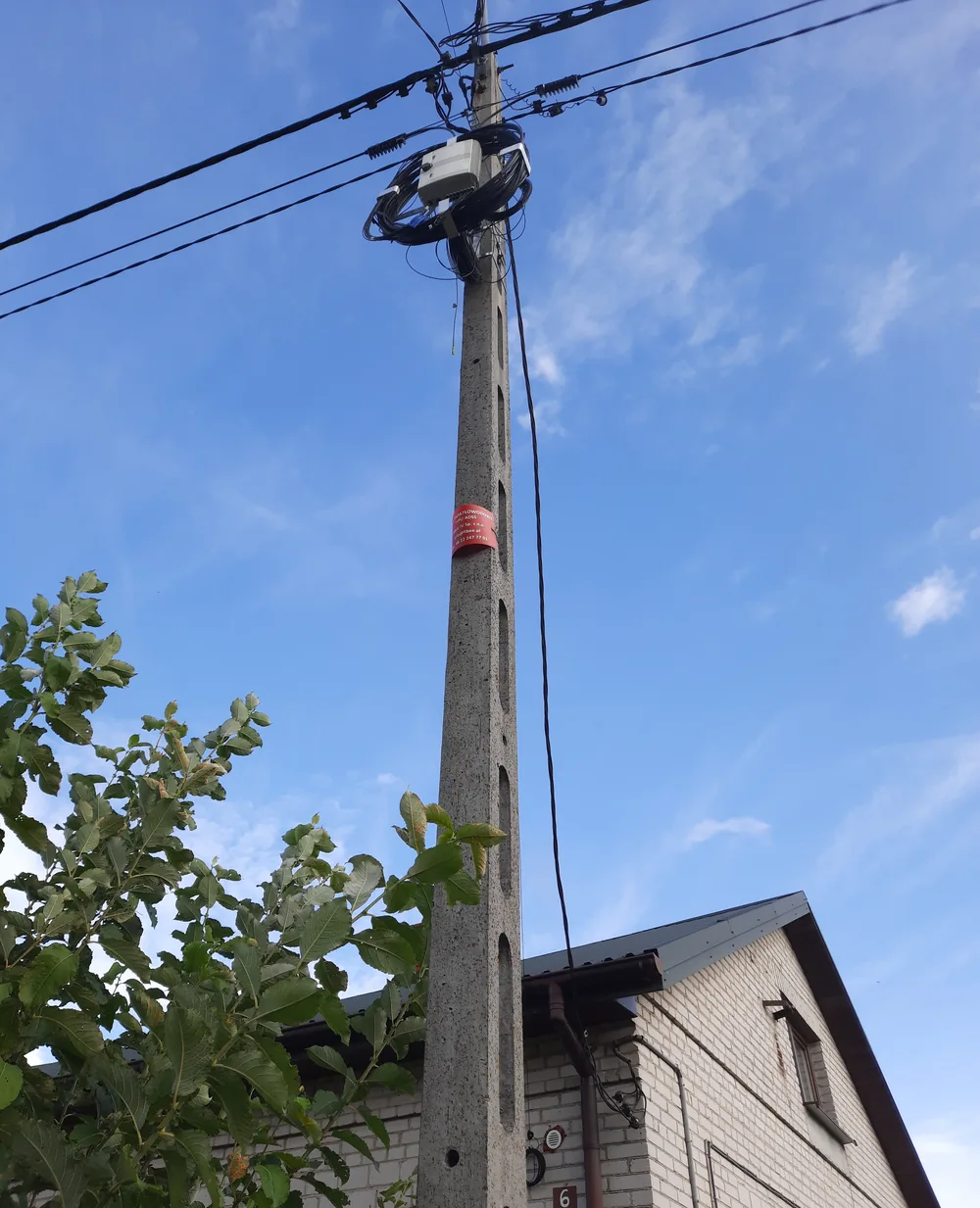 ADSS aerial fiber route with suspension fittings on a concrete pole