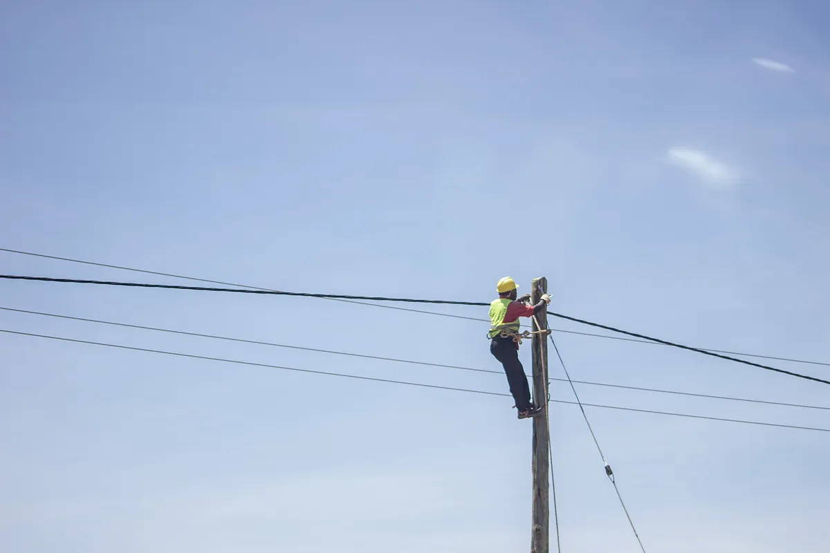 alley arm brace lineman step climber working on utility pole