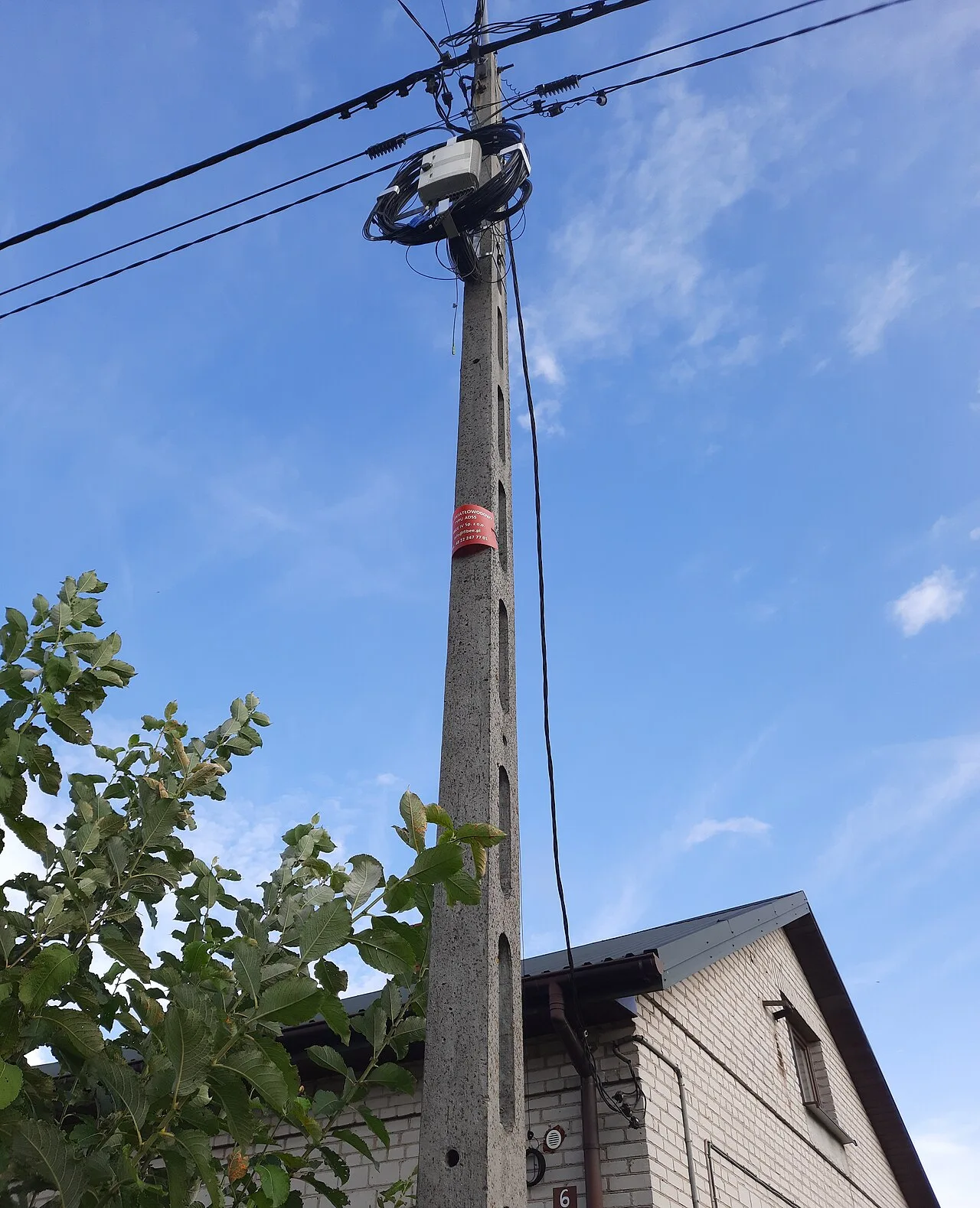 ADSS fiber optic cable route on a pole with stored slack loops