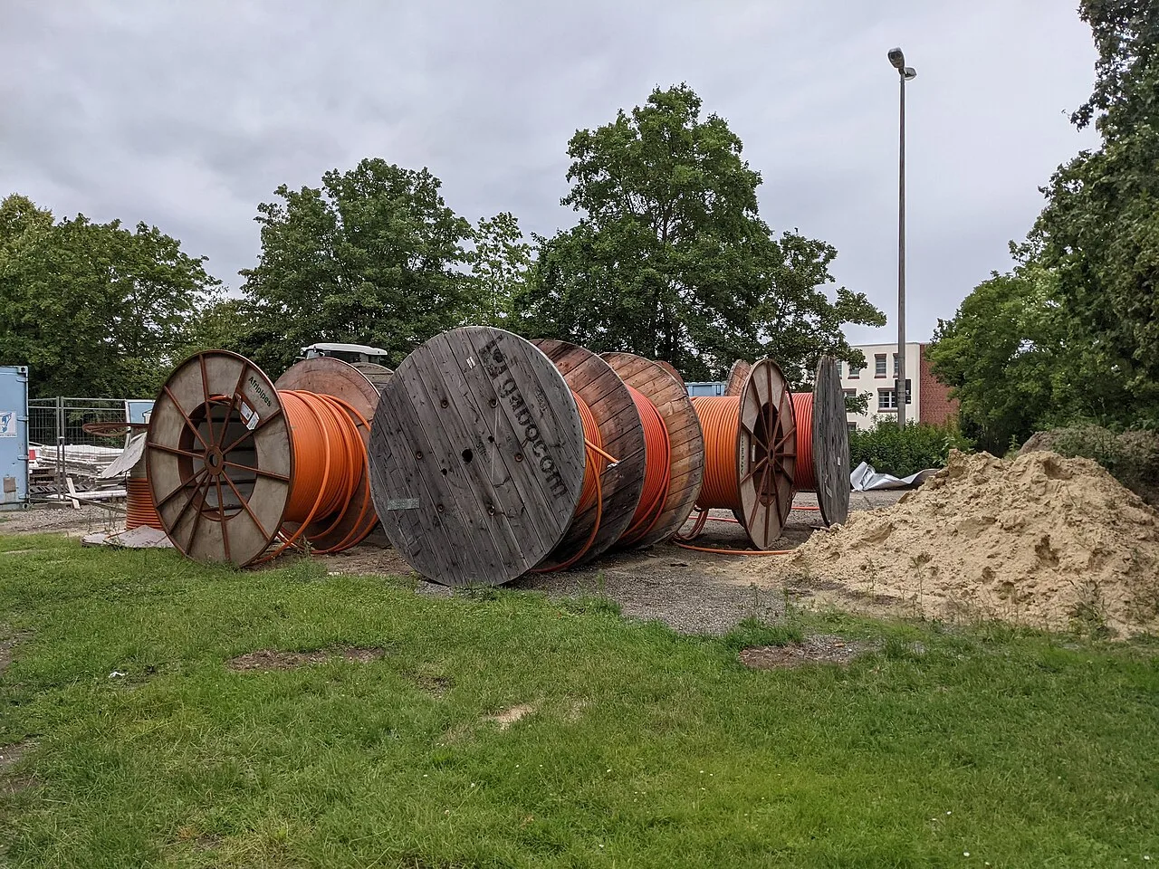 Fiber optic cable drums staged at a construction site before an aerial build