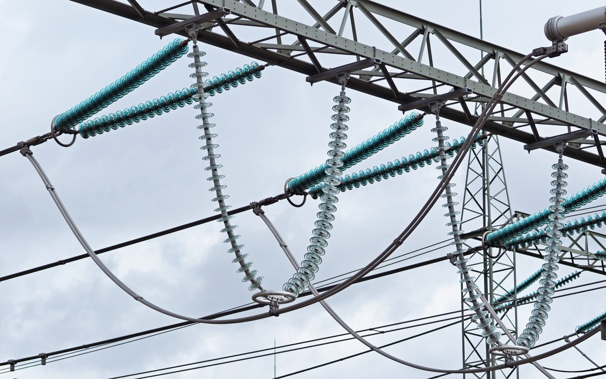 Cap-and-pin insulator strings hanging from a substation gantry