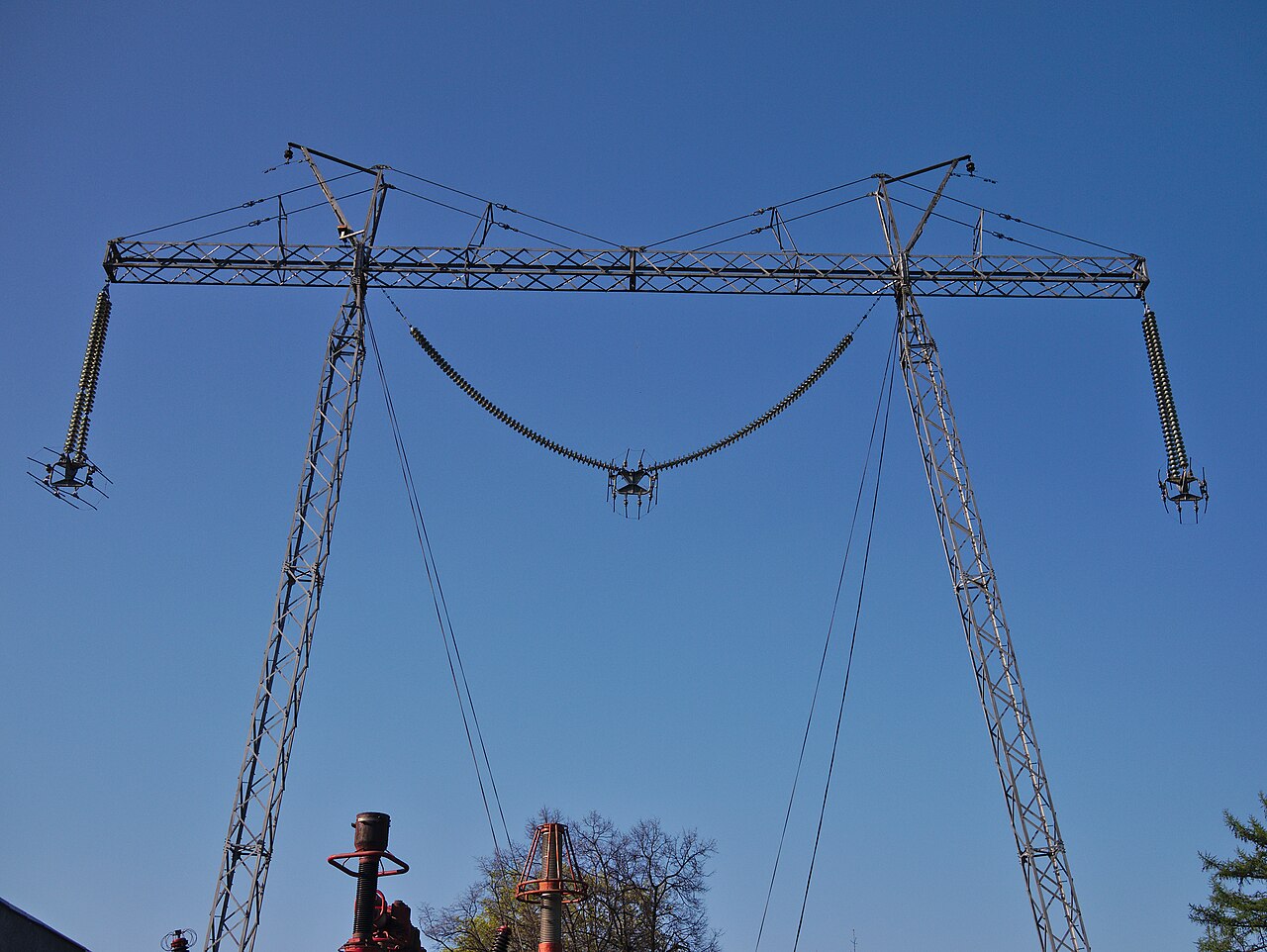 Suspension insulator strings hanging from a lattice test pylon