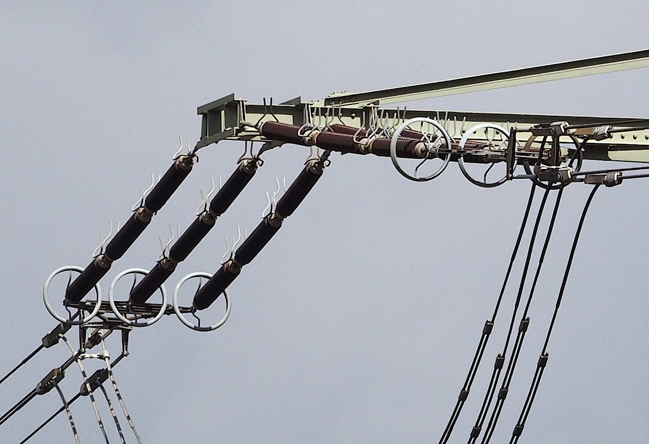 Ring fittings mounted on insulator strings at a transmission tower