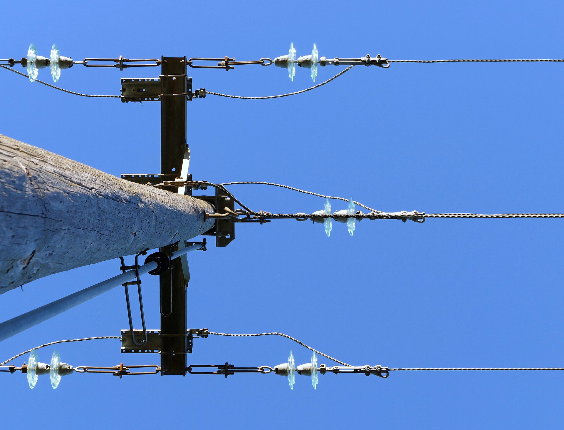 Dead-end distribution pole top with strand terminations, turnbuckles and insulator fittings