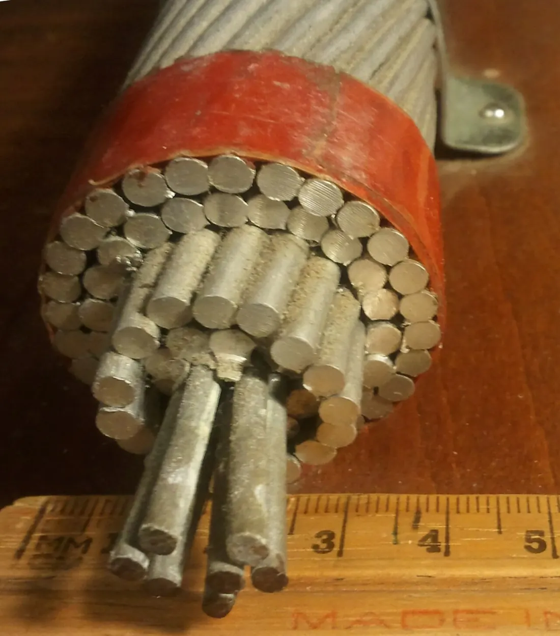 ACSR strand cross section showing wire construction against a ruler