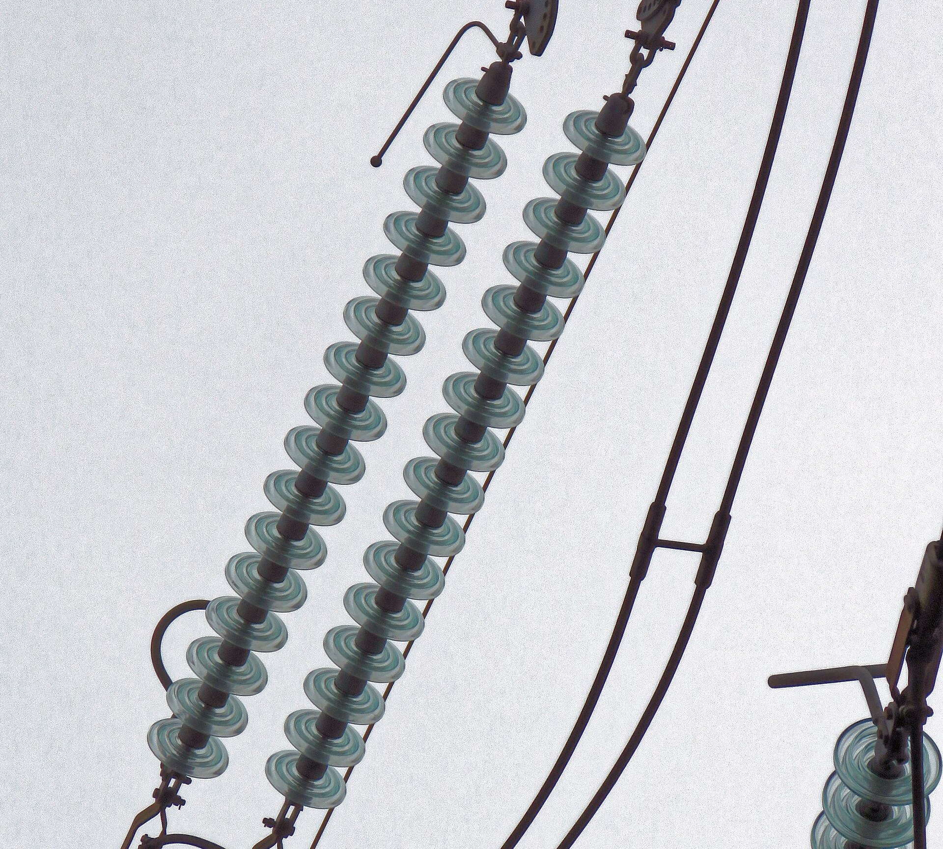 Toughened glass disc insulator strings on a transmission tower