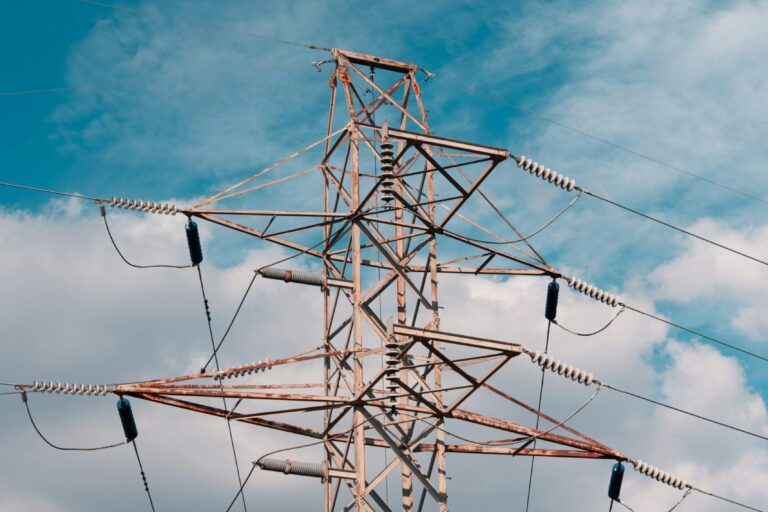 A high voltage power line with a blue sky in the background