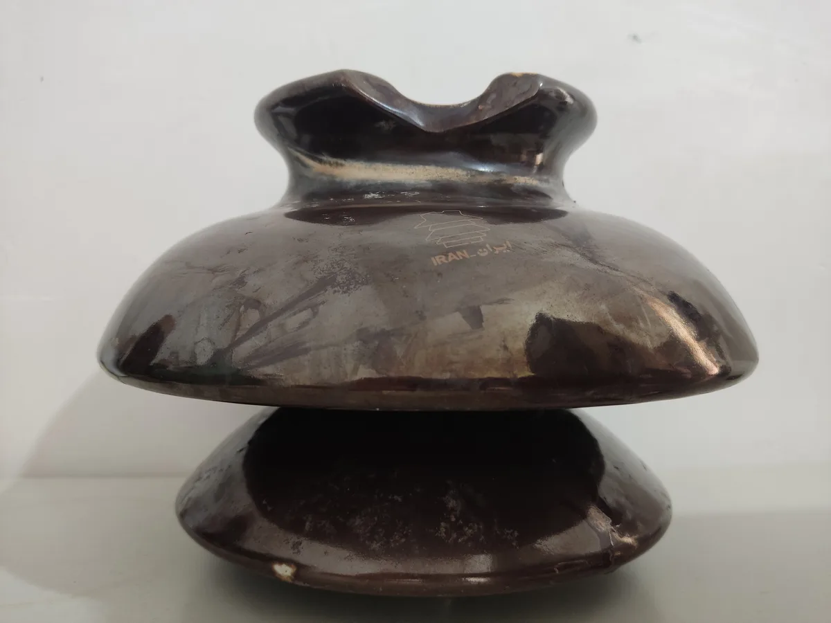 Close-up of a pin insulator showing the top groove and skirts