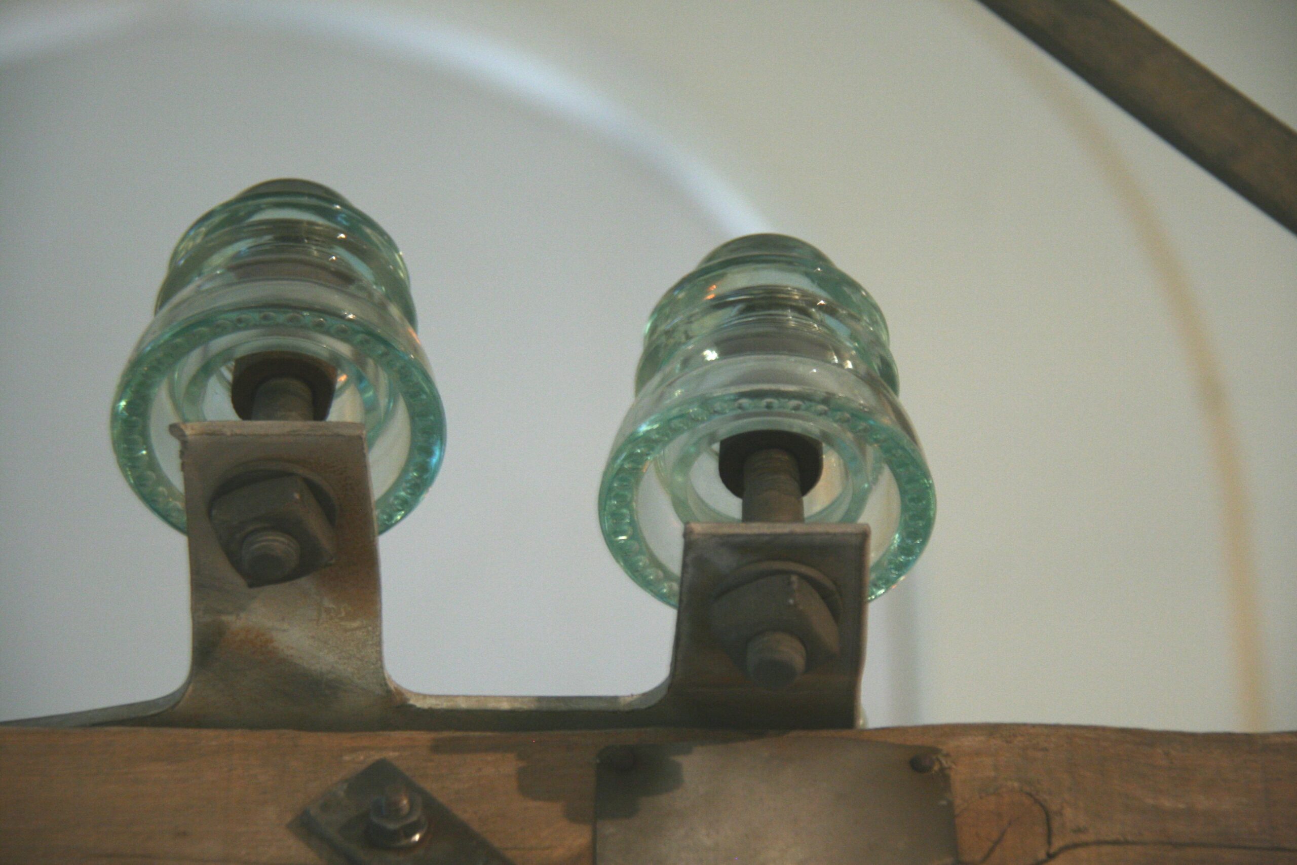 Glass pin insulator threaded onto a steel pin