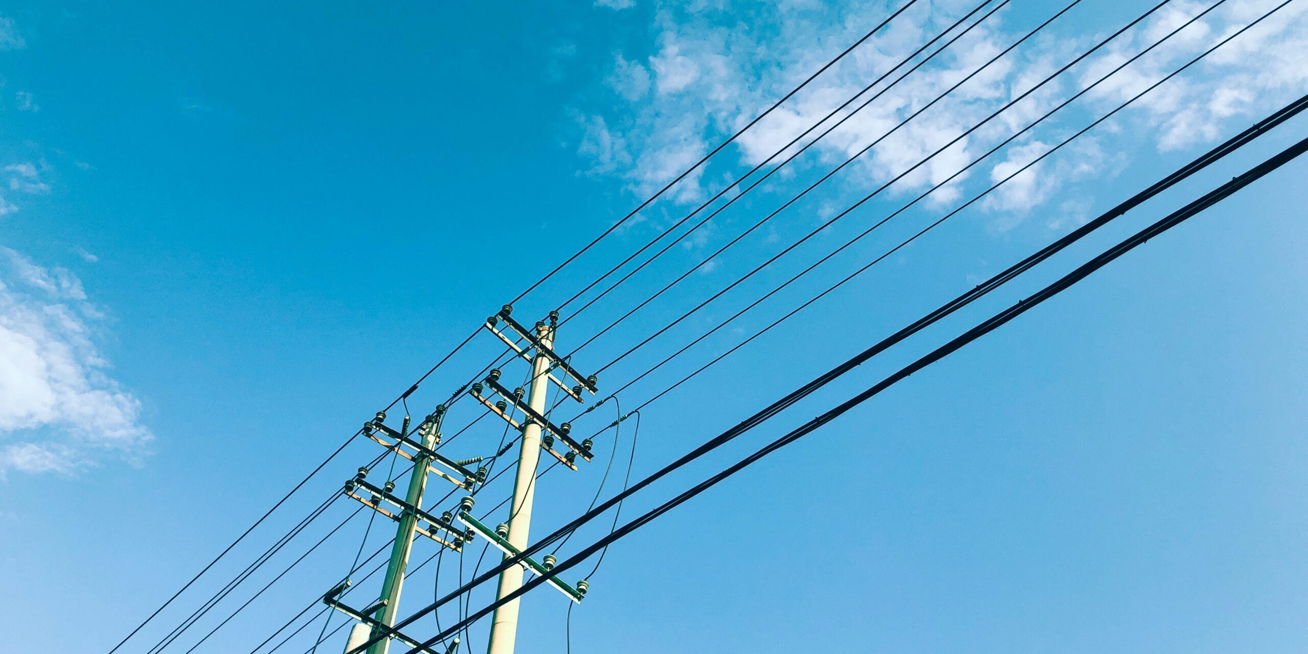power lines and telephone poles against a blue sky power lines and telephone poles against a blue sky