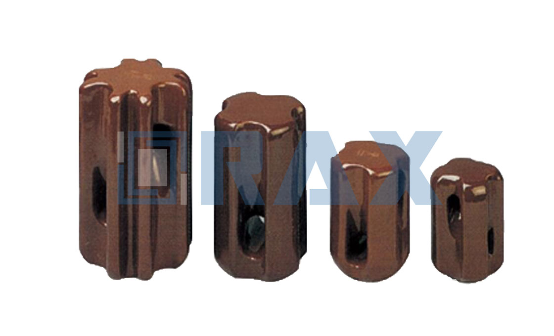 Four porcelain stay insulators of increasing height and waist size in a row