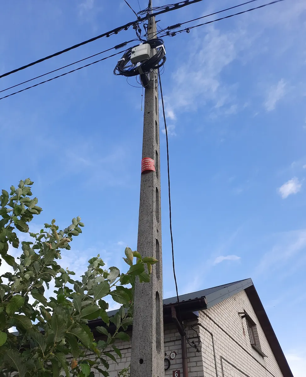 ADSS FTTH aerial cable mounted on a wood pole