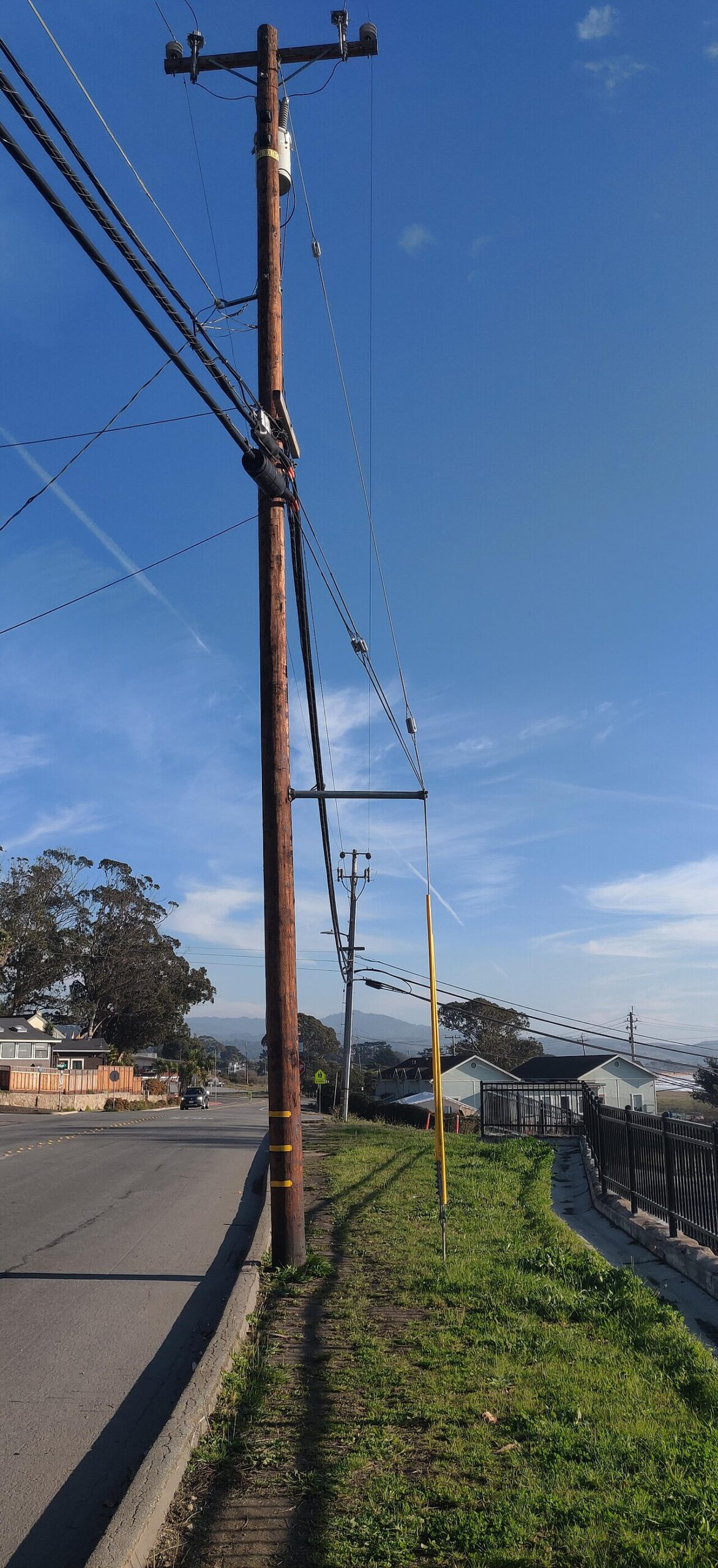 Down guy wire running from distribution pole to anchor at set lead