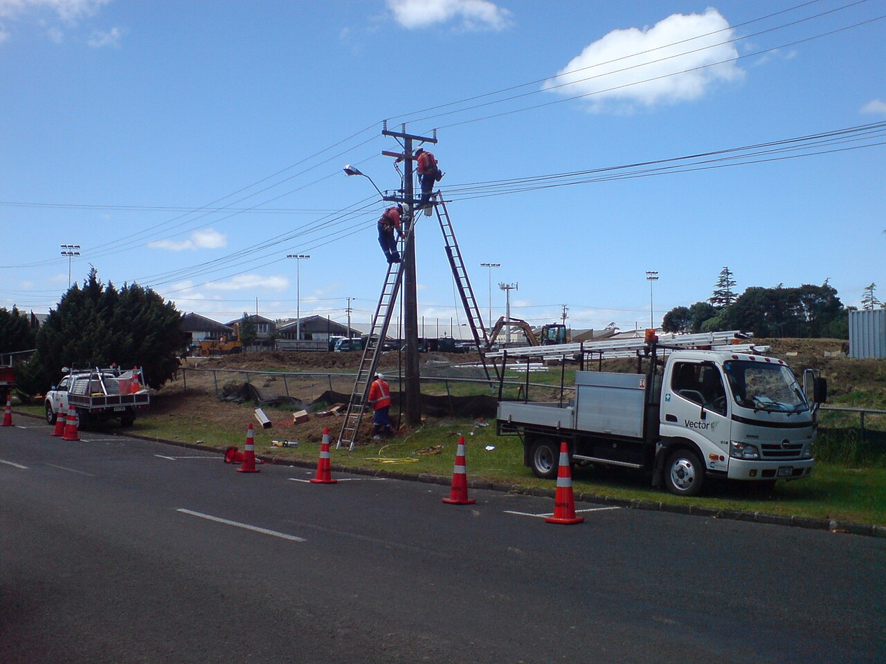 Linemen working on a distribution pole after guy installation